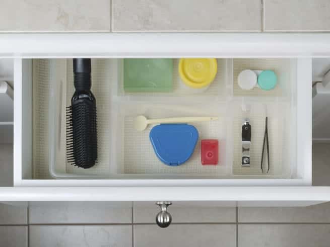 Header - Open bathroom drawer with personal hygiene accessories displayed